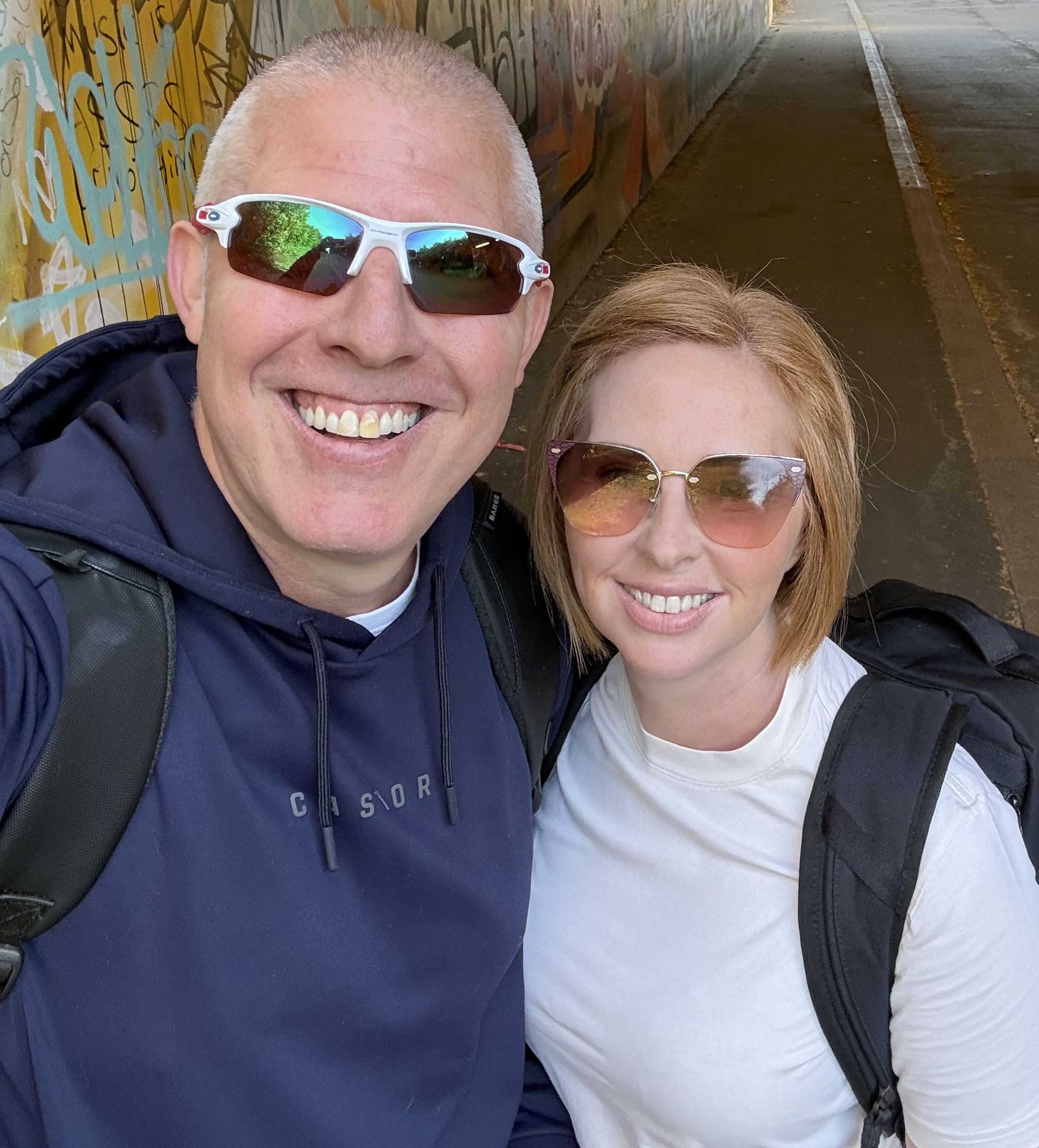 Justin and Emma Kennedy smiling together outdoors
